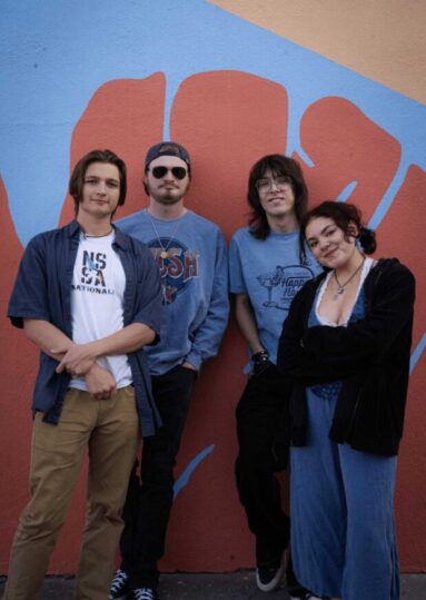 Ballpark the band posing infront of the fort collins mural